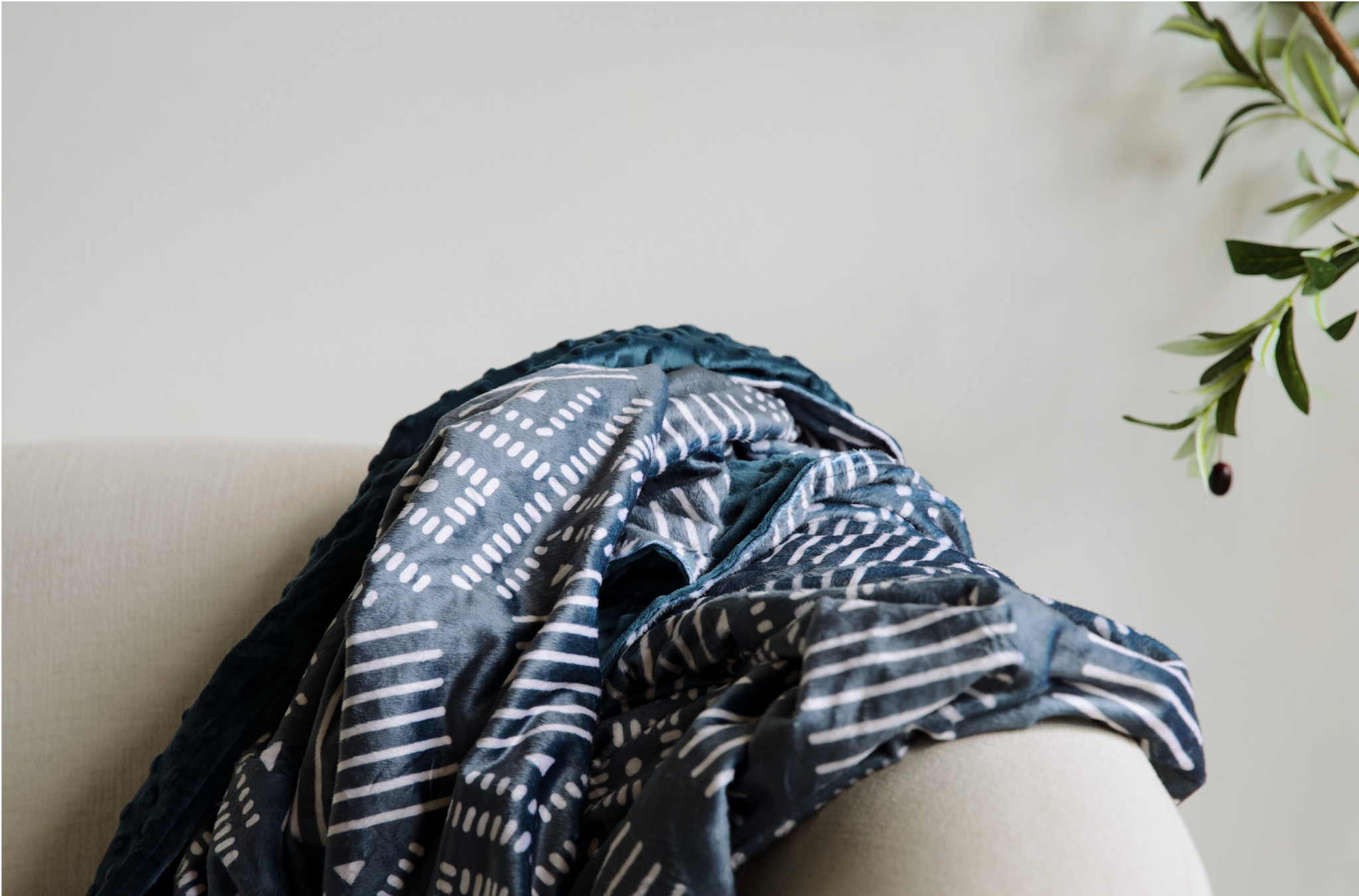 Kijani Throw Blanket in teal with geometric patterned front and solid textured back — large 60" x 80" African-inspired reversible blanket by Sinzia Comfort